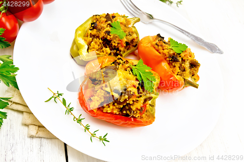 Image of Pepper stuffed with mushrooms and couscous in plate on board