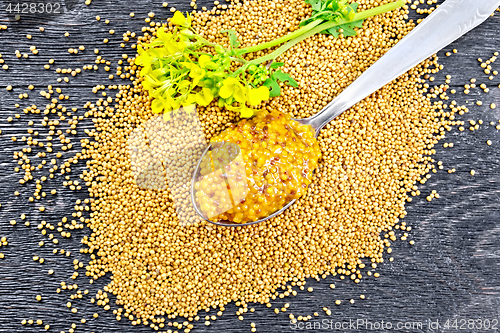 Image of Sauce mustard Dijon in spoon with flower on board top