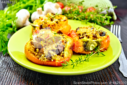 Image of Pepper stuffed with mushrooms and couscous in green plate