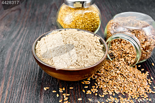 Image of Flour linen in bowl with seeds in glass jars on wooden table