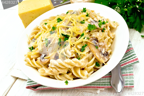 Image of Fusilli with mushrooms on light board