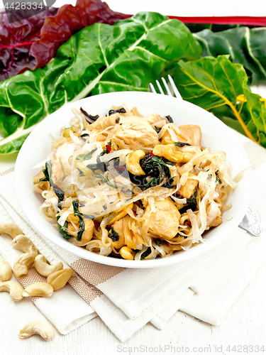 Image of Funchoza with chard and meat in bowl on light board