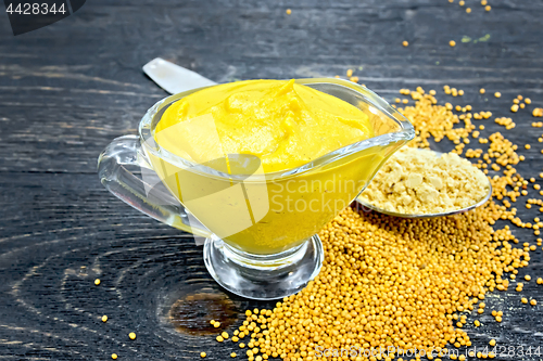 Image of Sauce mustard in sauceboat with powder on board