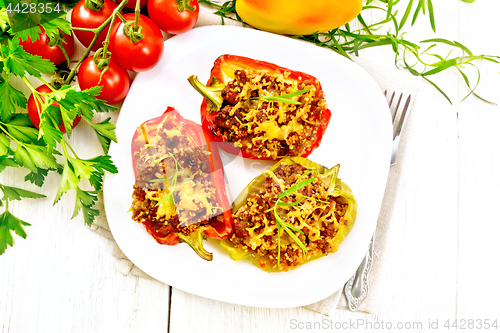 Image of Pepper stuffed with meat and couscous in plate on light board to