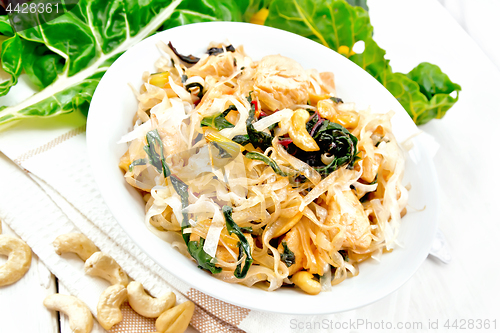 Image of Funchoza with chard and meat in bowl on board