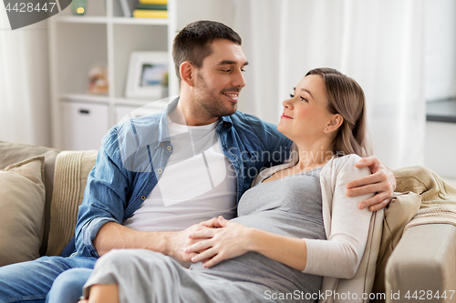 Image of man hugging pregnant woman at home