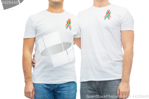 Image of close up of couple with gay pride rainbow ribbons