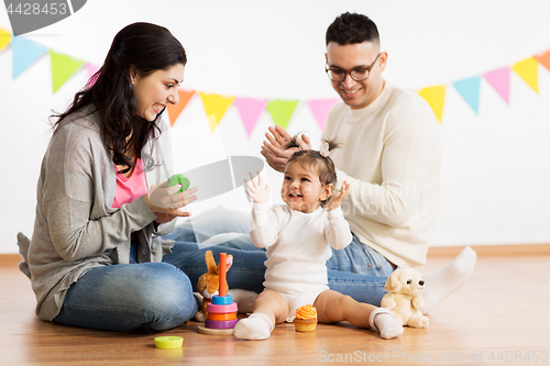 Image of baby girl with parents playing and clapping hands