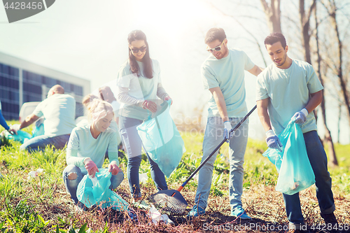 Image of volunteers with garbage bags cleaning park area