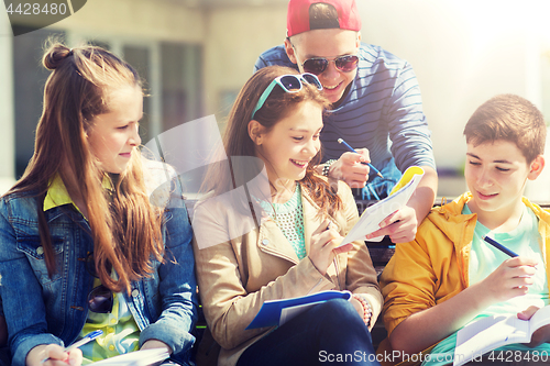 Image of group of students with notebooks at school yard