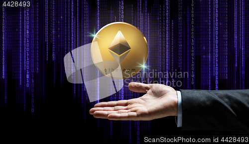 Image of businessman hand with ethereum over binary code