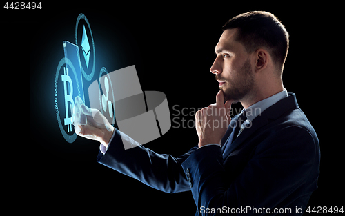 Image of businessman with tablet pc and cryptocurrency