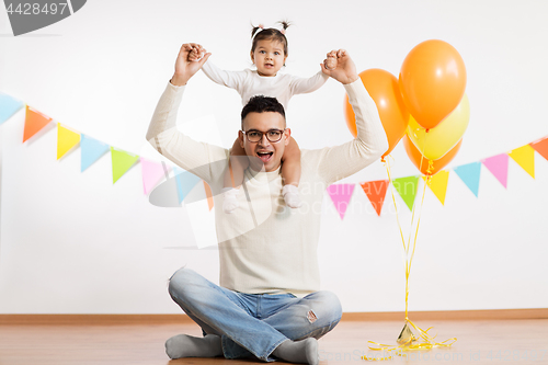 Image of father and daughter with birthday party balloons