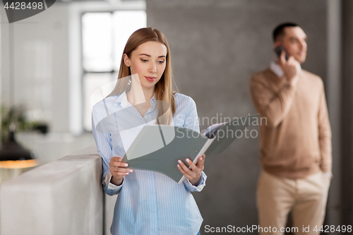 Image of female office worker with folder