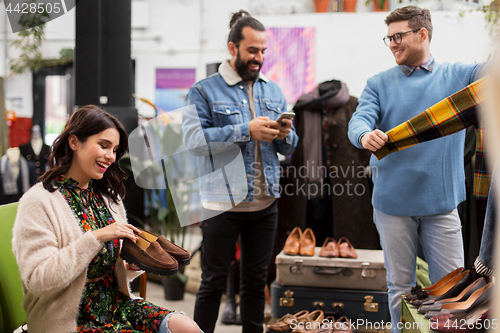 Image of friends choosing clothes at vintage clothing store