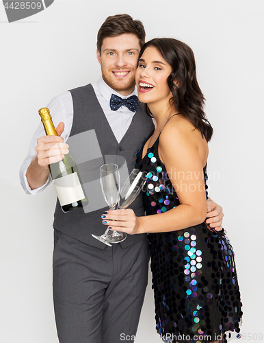 Image of happy couple with champagne and glasses at party