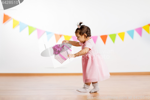 Image of happy baby girl with gift box on birthday party