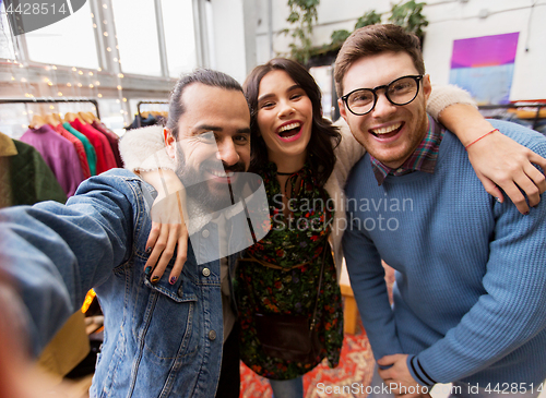 Image of friends taking selfie at vintage clothing store