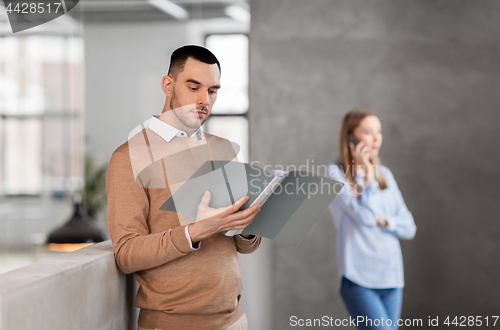 Image of male office worker with folder