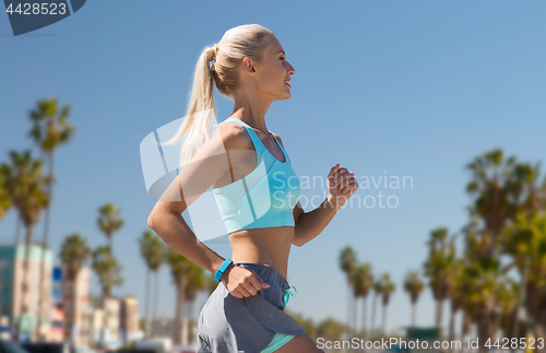 Image of woman with fitness tracker running