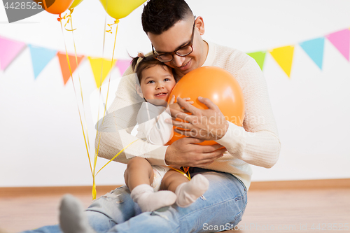 Image of father and daughter with birthday party balloons