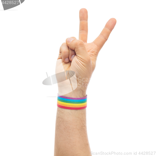 Image of hand with gay pride rainbow wristband make peace