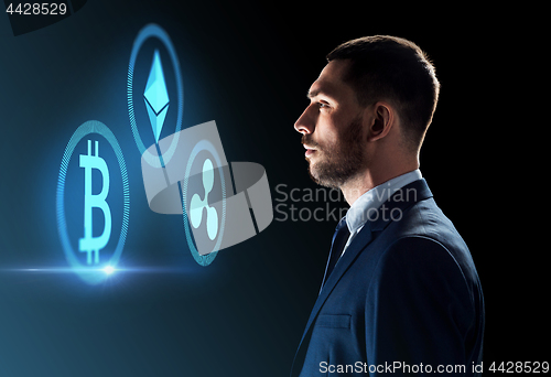 Image of buisnessman looking at cryptocurrency icons