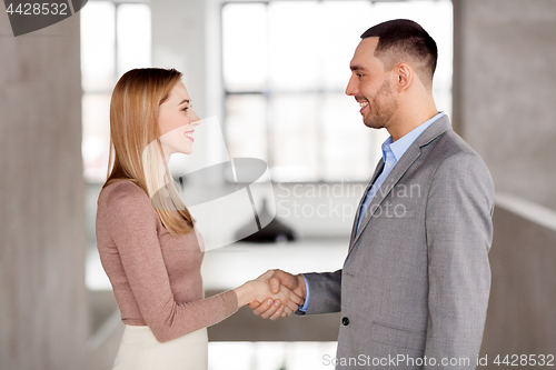 Image of smiling businesswoman and businessman at office