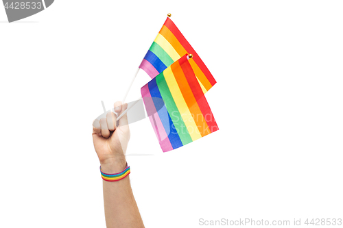 Image of hand with gay pride rainbow flags and wristband