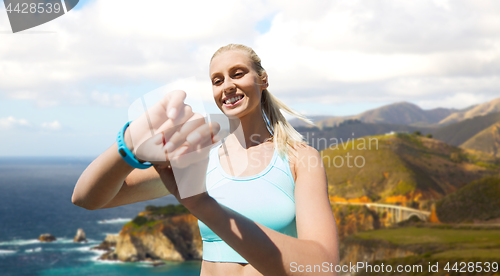 Image of woman with fitness tracker exercising outdoors
