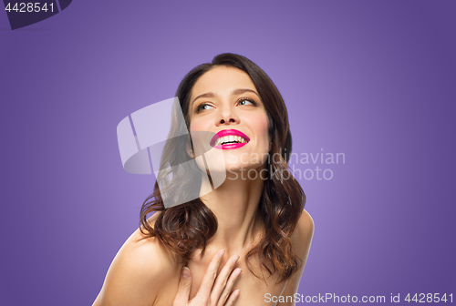 Image of beautiful smiling young woman with pink lipstick