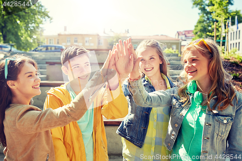 Image of happy students or friends making high five