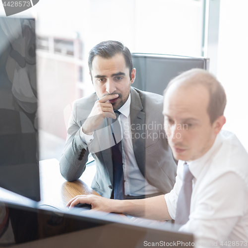 Image of Business team analyzing data at business meeting.