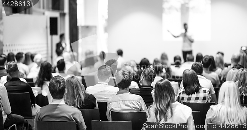 Image of Business speaker giving a talk at business conference event.