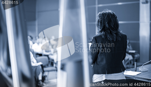 Image of Public speaker giving talk at Business Event.