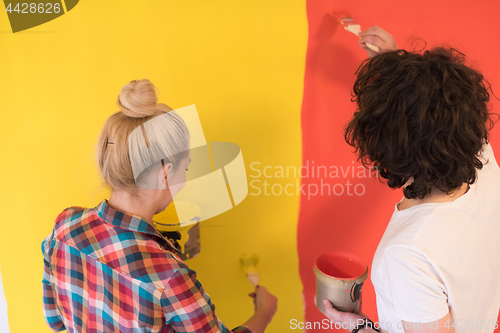 Image of couple painting interior wall