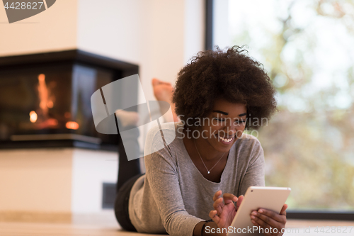 Image of black women using tablet computer on the floor