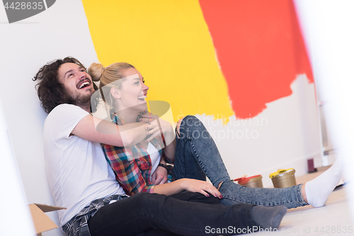 Image of Happy young couple relaxing after painting