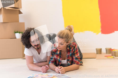 Image of Happy young couple relaxing after painting