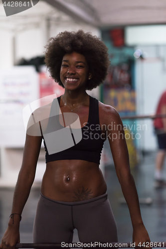 Image of black woman lifting empty bar