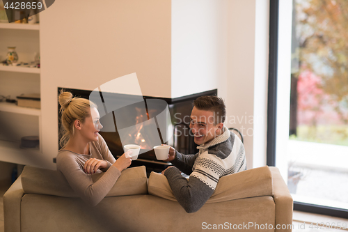 Image of Young couple  in front of fireplace