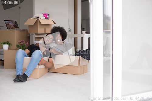 Image of African American couple  playing with packing material