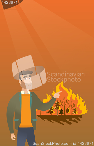 Image of Man standing on the background of wildfire.