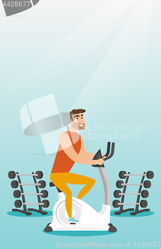 Image of Young man riding stationary bicycle.