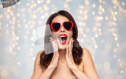 Image of woman with red lipstick and heart shaped shades