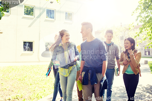 Image of group of happy teenage students walking outdoors