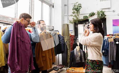 Image of friends photographing at vintage clothing store