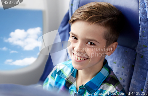 Image of happy boy travelling by plane