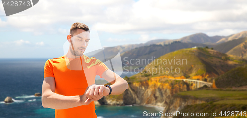 Image of man with fitness tracker training outdoors