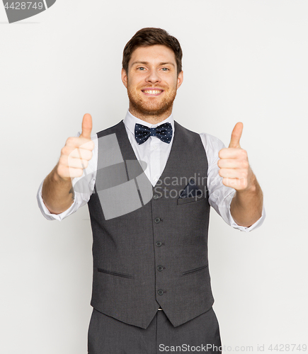 Image of happy man in festive suit showing thumbs up